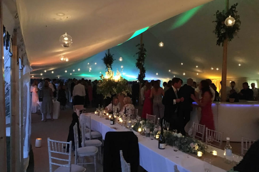 Bauble lights and ivory lining in 120' x 40' marquee with round bar. e